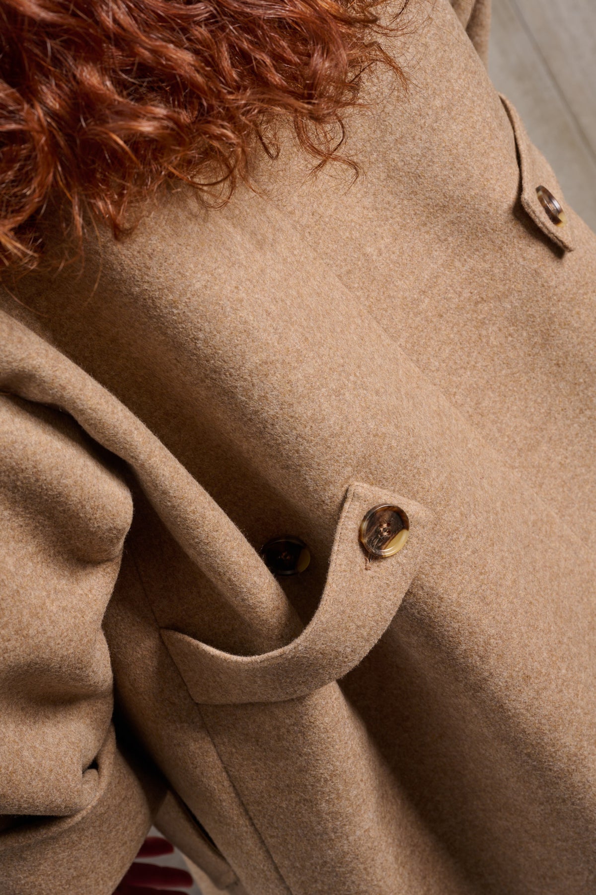 Manteau croisé oversize de la marque Aïdama, modèle Haomi en laine et cachemire beige. Porté ouvert par une mannequin femme et vu de dos, zoomé sur le tissu.
