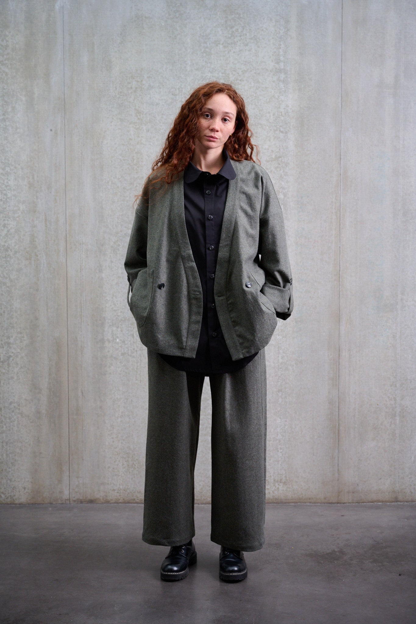 Pantalon droit de la marque Aïdama, coupe large en flanelle de laine grise. Porté par une mannequin femme et vue de face.
