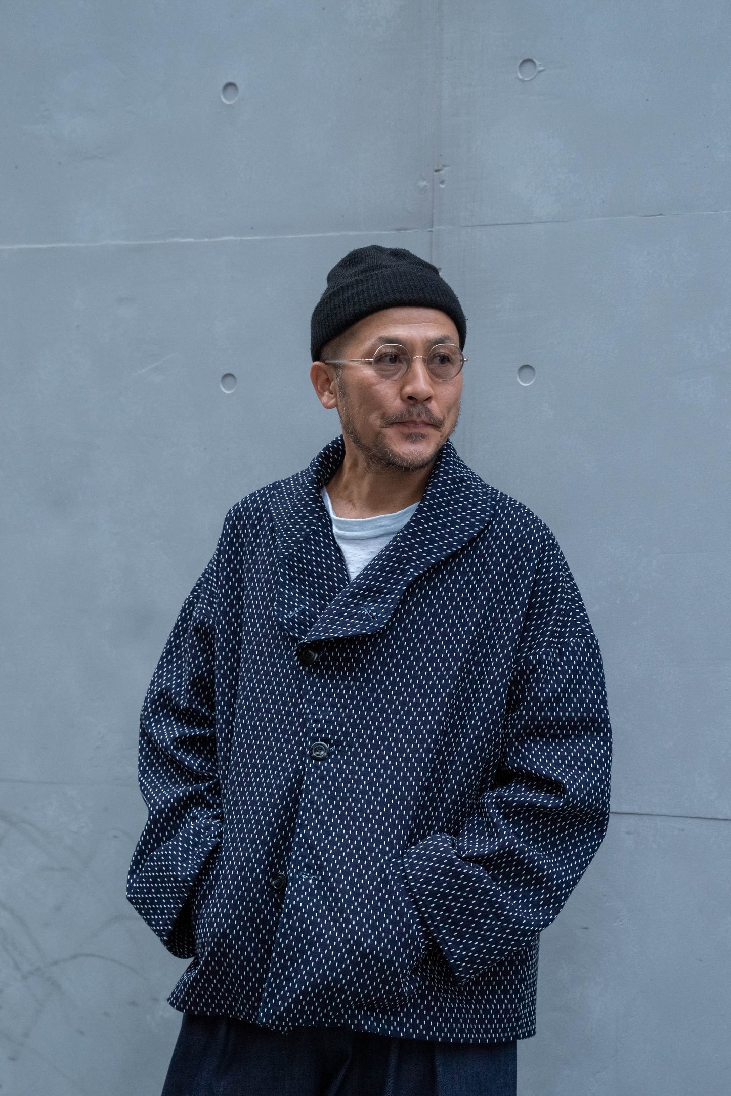 Veste oversize à col arrondi de la marque Aïdama, modèle Gunbai en coton japonais bleu brodé de points Sashiko. Portée par un mannequin homme et vue de face. 