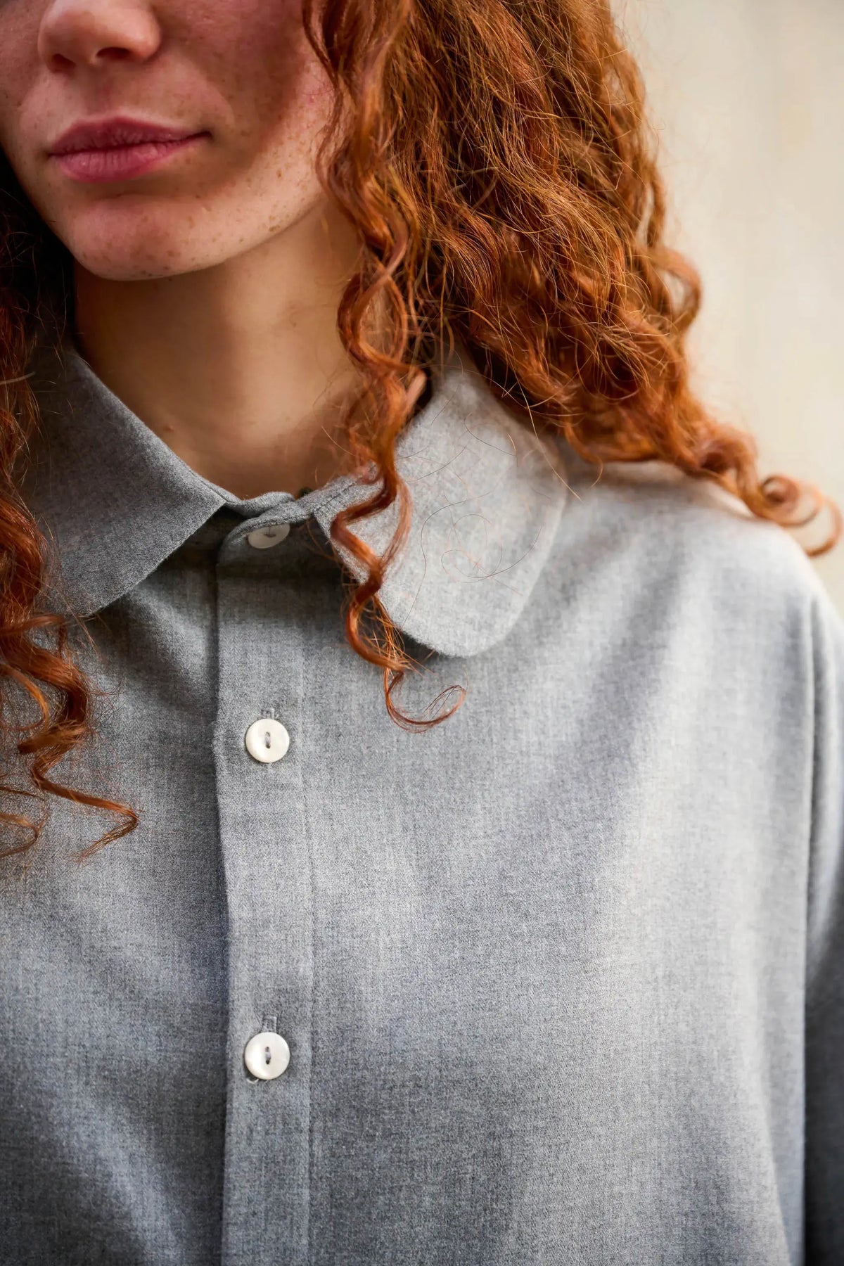 Chemise oversize arrondie de la marque Aïdama, modèle Marui en coton gratté gris clair. Porté par une mannequin femme et vue de face zoomée sur le col.