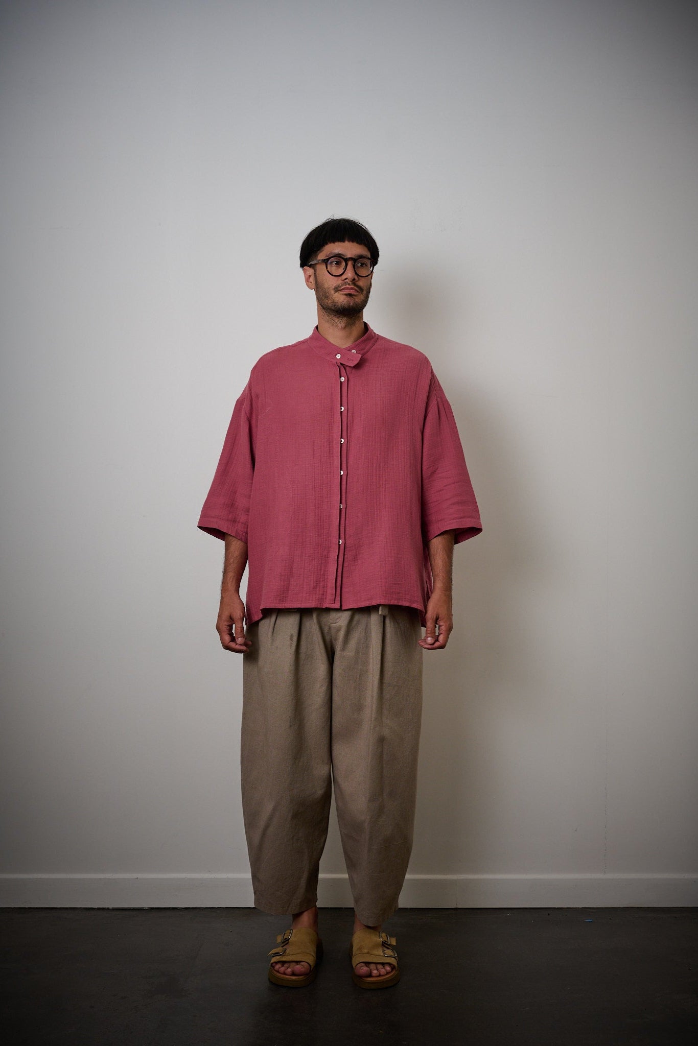 Chemise oversize à col officier de la marque aidama, modèle kita, coupe boxy en gaze de coton framboise. Portée par un mannequin homme et vu de face.