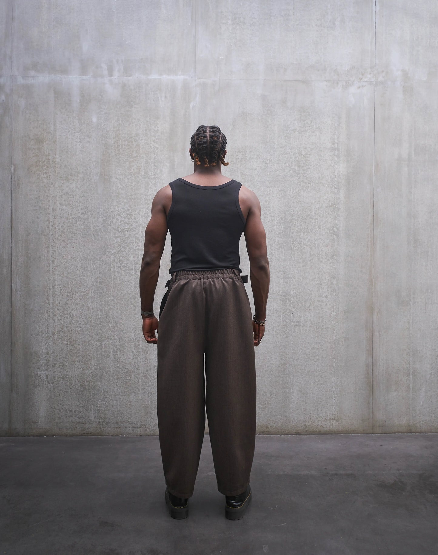Pantalon circulaire Aïdama, coupe ballon en laine froide marron chiné. Porté par un mannequin homme et vu de dos.