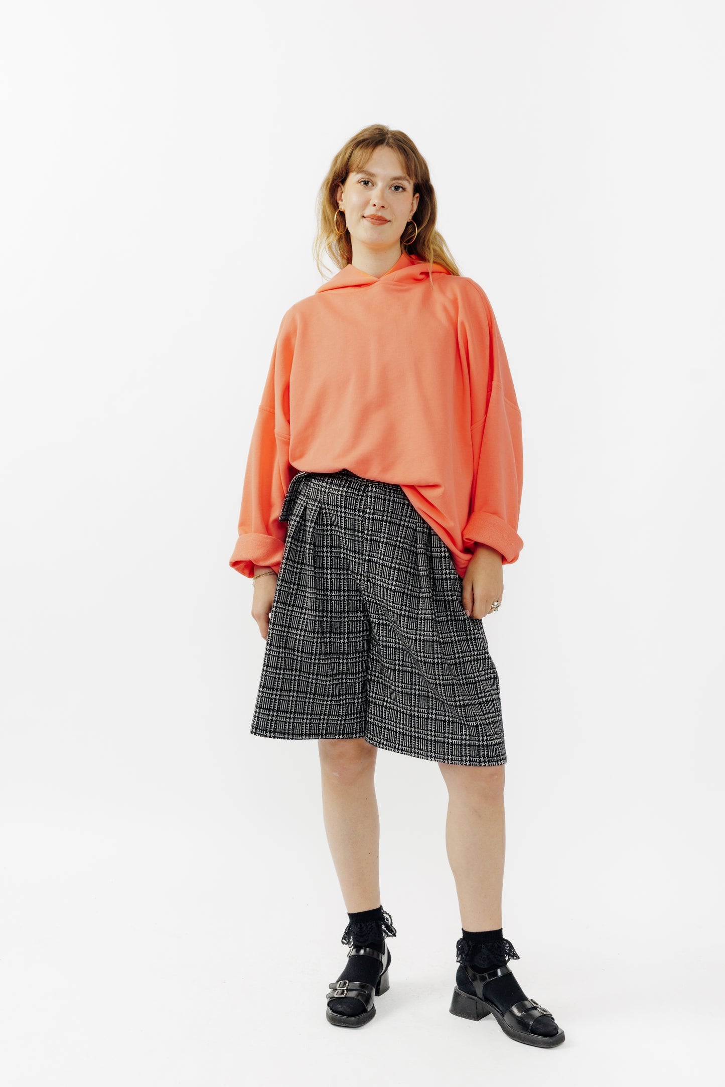 Sweat à capuche oversize Mino de la marque Aïdama en molleton de coton corail. Porté par une mannequin femme et vu de face.