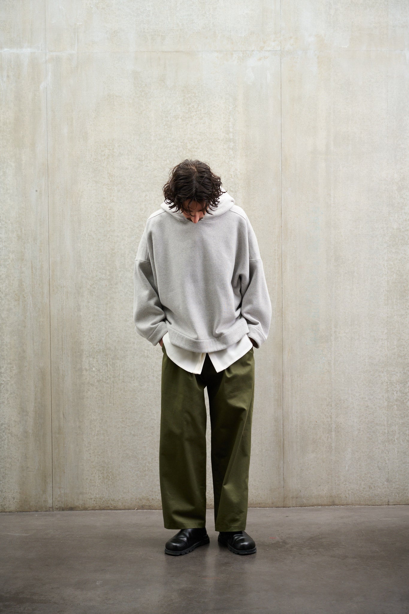 Sweat à capuche oversize en molleton de coton gris chiné Mino de la marque Aïdama. Porté par un mannequin homme et vu de face.