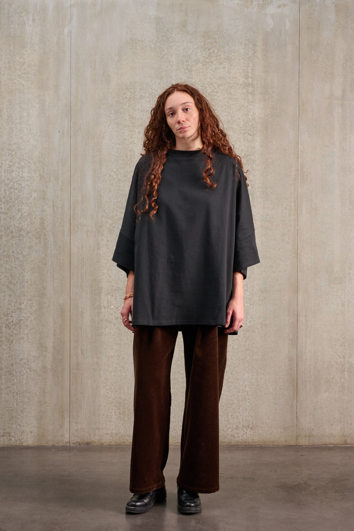 T-shirt oversize à col bateau de la marque Aïdama, modèle Haku en jersey de coton noir épais. Porté par une mannequin femme et vu de face.