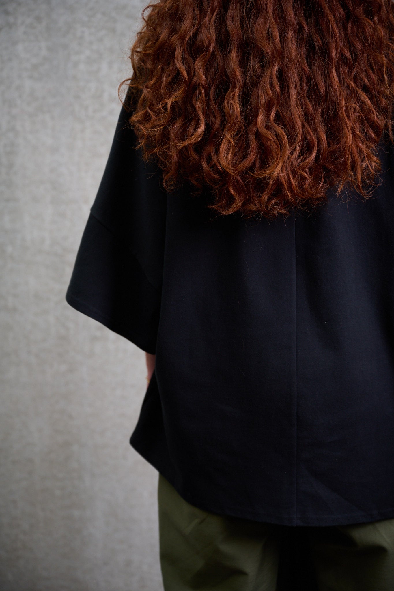 T-shirt oversize à col bateau Haku en coton épais noir de la marque Aïdama. Porté par une mannequin femme et vu de zoomé de dos.