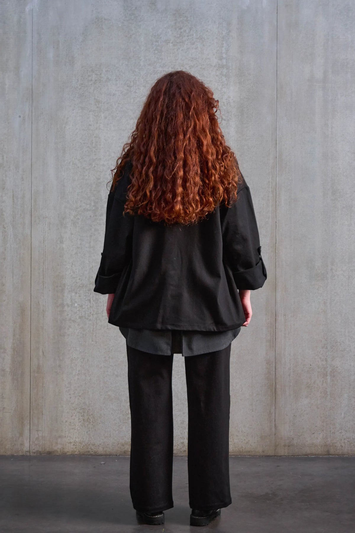 Veste oversize à col kimono de la marque Aïdama, modèle Samue en sergé de coton noir. Portée ouverte par une mannequin femme et vue de dos.